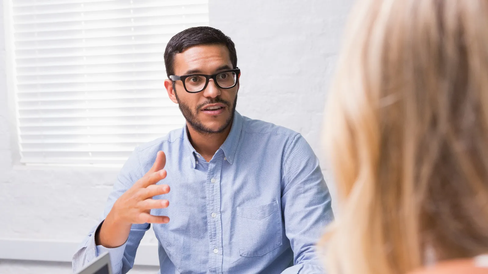 Young businessman interviewing a woman.