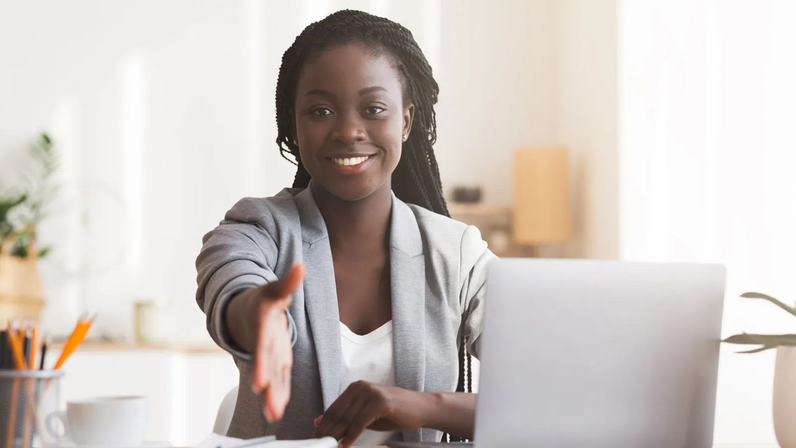 Business woman holding out her hand for a handshake.