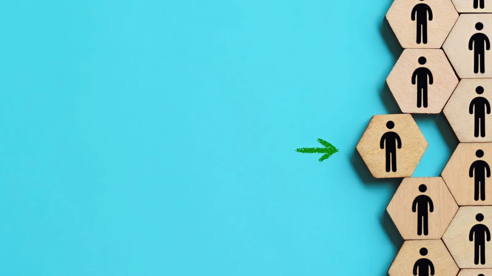 A close up of wooden hexagon blocks with a body silhouette printed on them against a blue background.