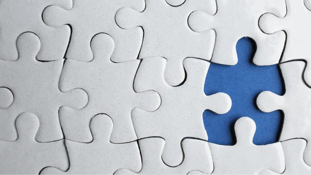 A puzzle with one piece missing.